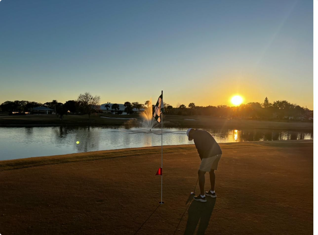 Golfer putting at sunset on a Florida course